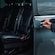 A private driver opening the door of a luxury minivan